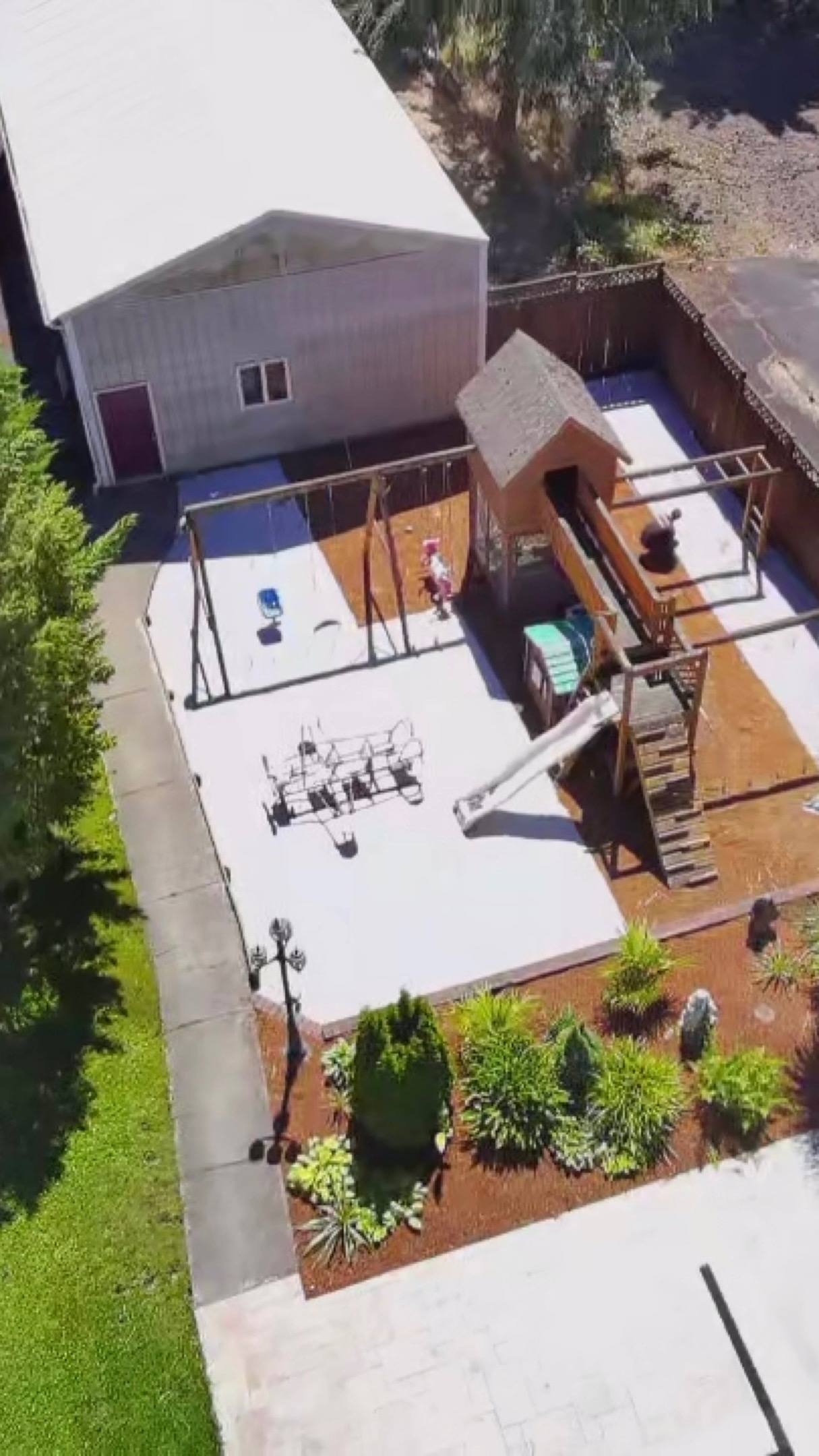 Patio and grounds seen from above with surrounding plantings
