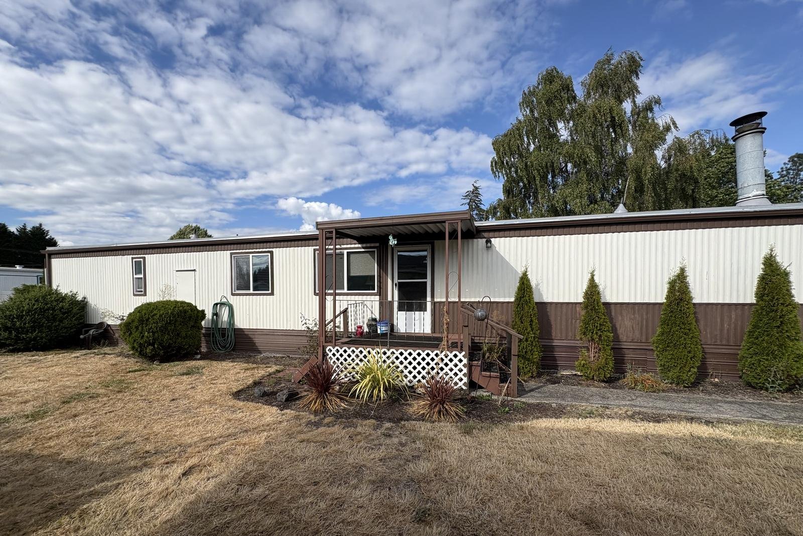 A property before landscaping, with bare dirt and no lawn