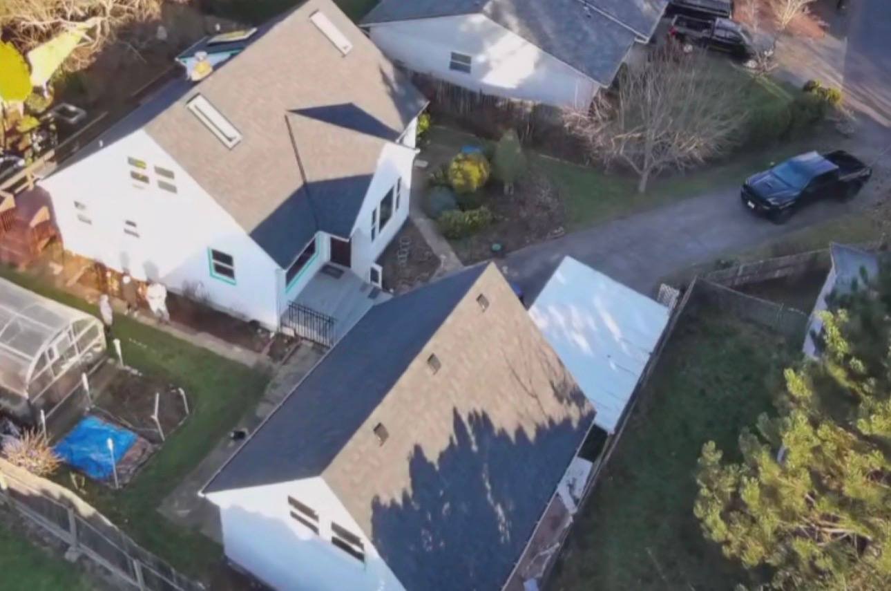 Aerial view of a completed roof replacement with a skylight