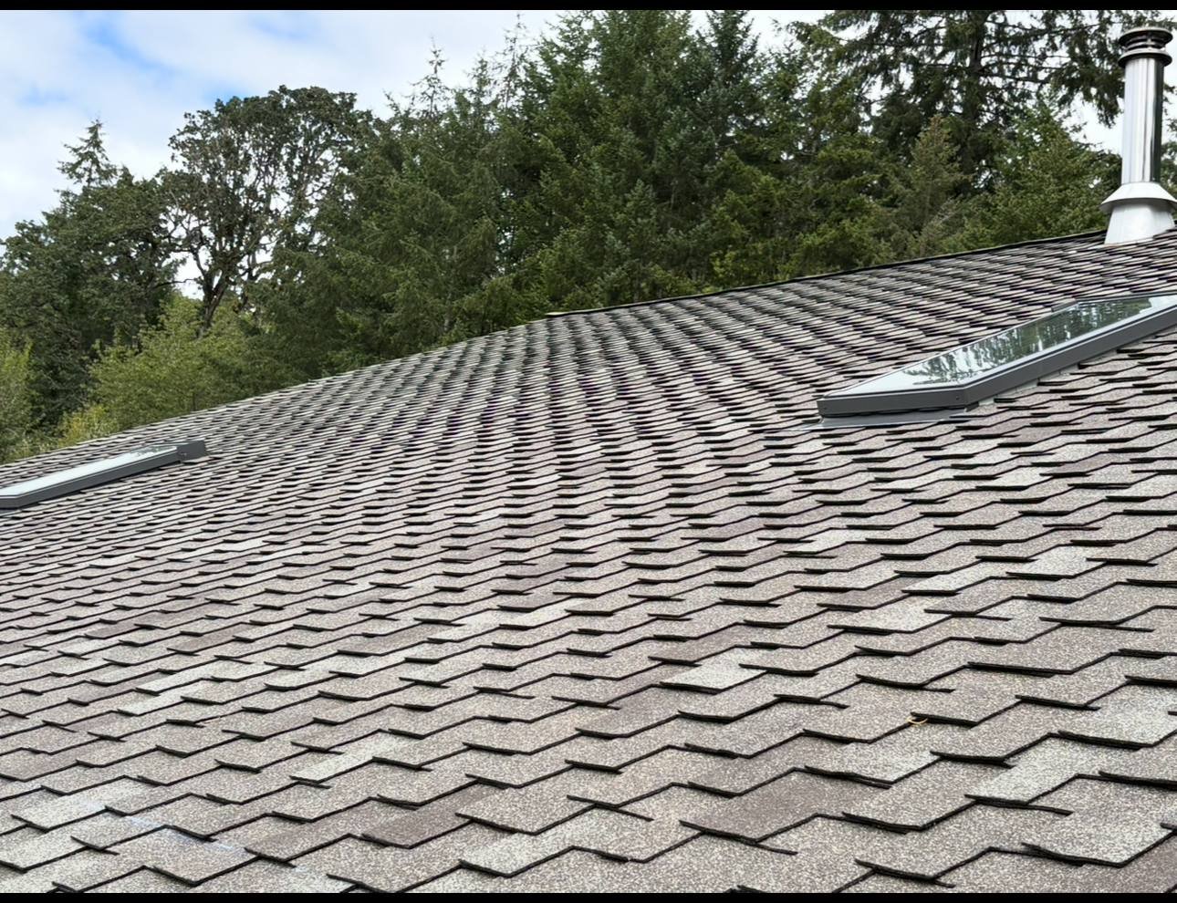 Finished roof with a skylight set into the shingle field